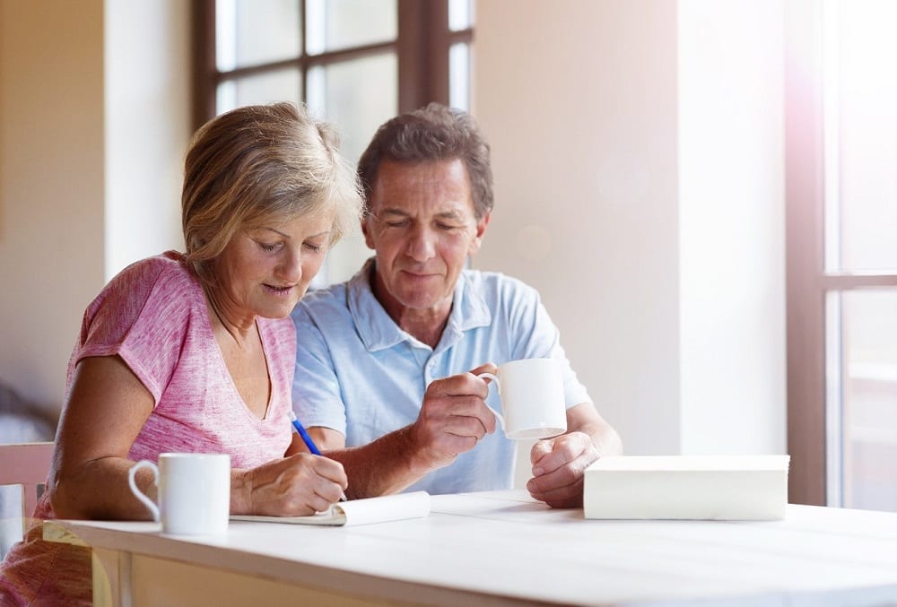 Retirement planning couple looking at an IRA vs 401(k)