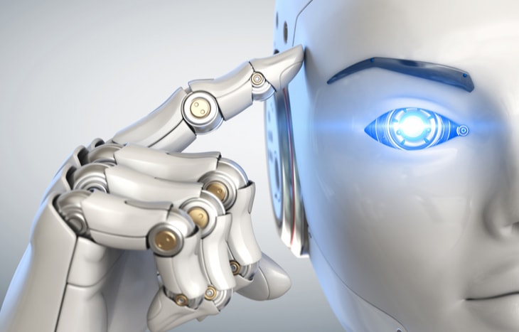 A robot pointing to her head with a lit up blue eye. Here are some AI stocks to watch in 2020.