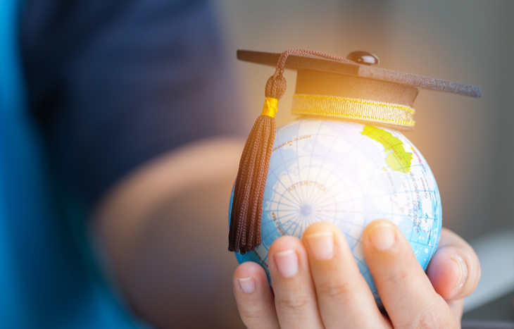 globe in hand and invest in education