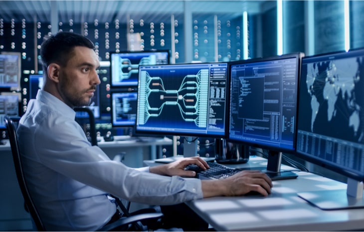 A security agent working at his desk for a cybersecurity company