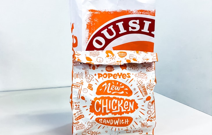 A bag of Popeye’s chicken sandwich, which helped Restaurant Brands International stock beat analysts earnings expectations.