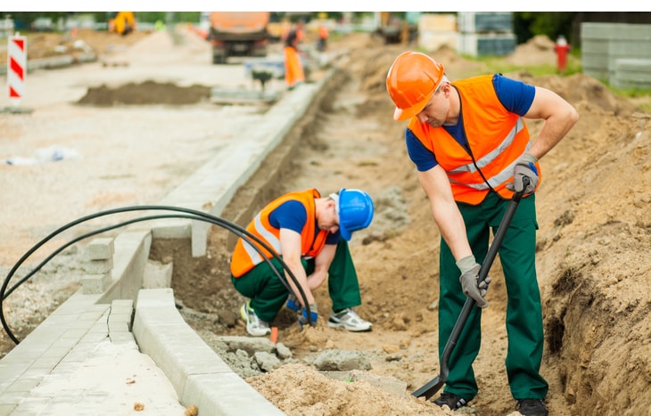 Construction workers are building a road that is funded by municipal bonds