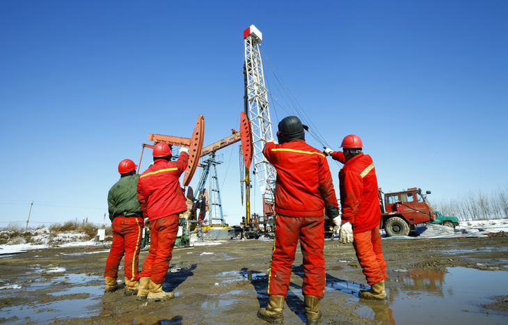 oil workers drilling and exploring