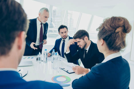 Business men at a board meeting discussing earnings season