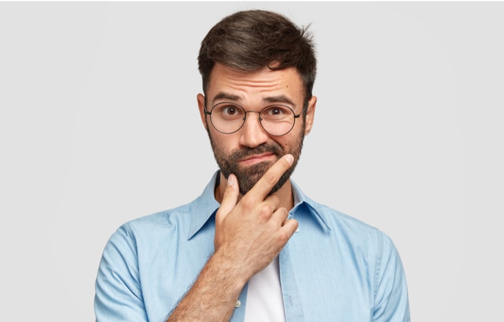 A man in a shirt and tie wonders, "will the economy get better in 2020"