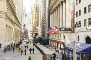 People walking on Wall Street where bank stocks may be soon taking off