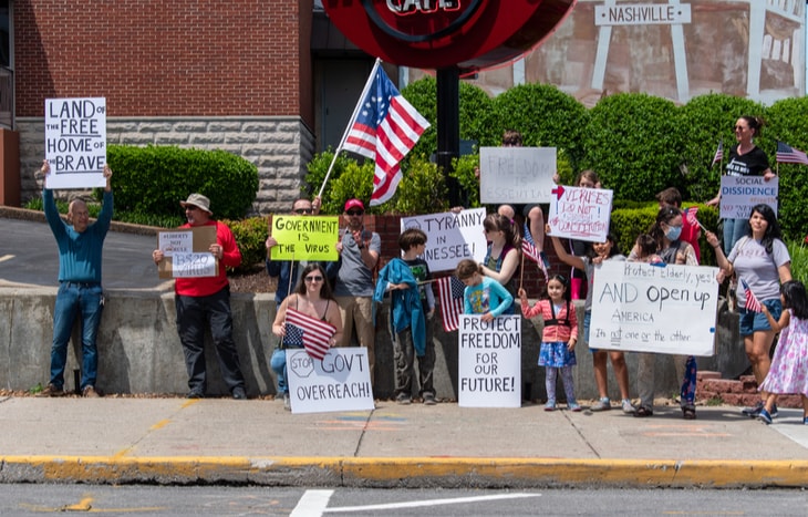 A crowd of people protesting quarantines for Coronavirus.