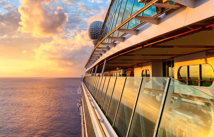 A cruise ship at sunset. Is it time to buy Royal Caribbean stock?