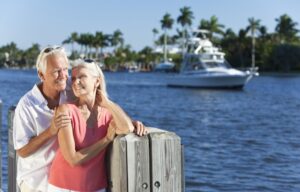 A happy wealthy couple cuddling on the docks - wealth creation tips