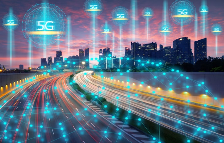 An image of a city lit up by a 5g cellular network - are you interested in 5g tech stocks?