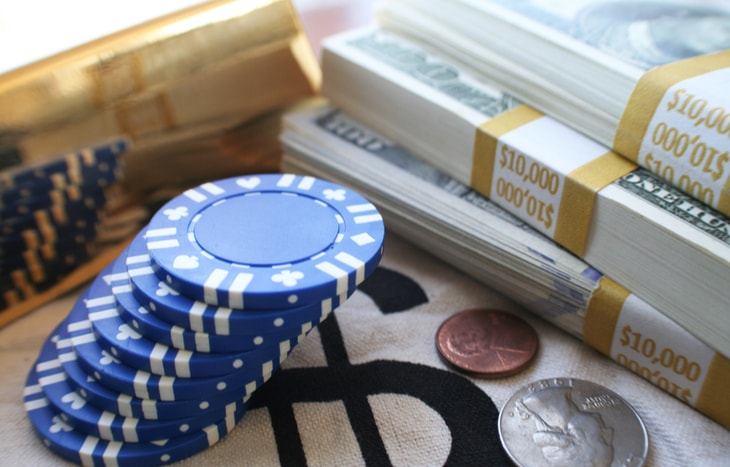 A stack of poker blue chips and money. The benefits of blue chip stocks are many.