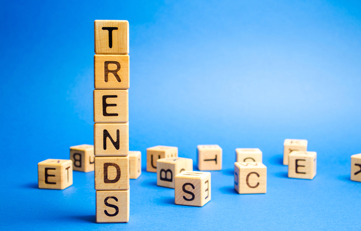 A stack of blocks against a blue background. The blocks spell out "trends" symbolizing trending stocks.