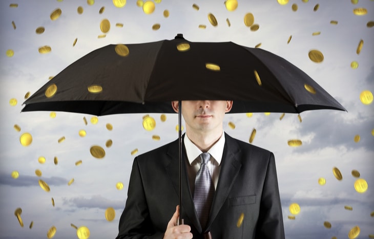 Gold coins rain down on a business holding an umbrella. It must be earnings season!