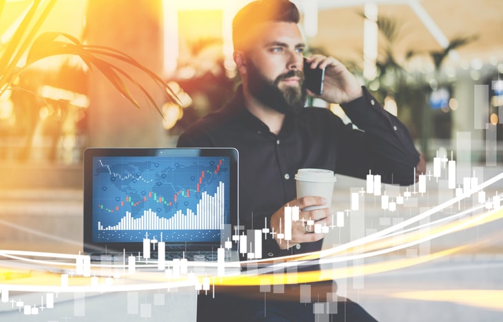 A trader dressed in black on the phone selling covered calls.