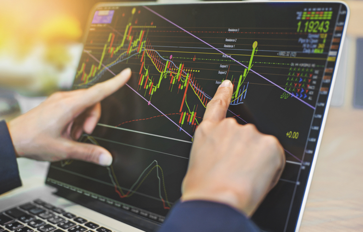 pointing to technical indicators on a computer screen