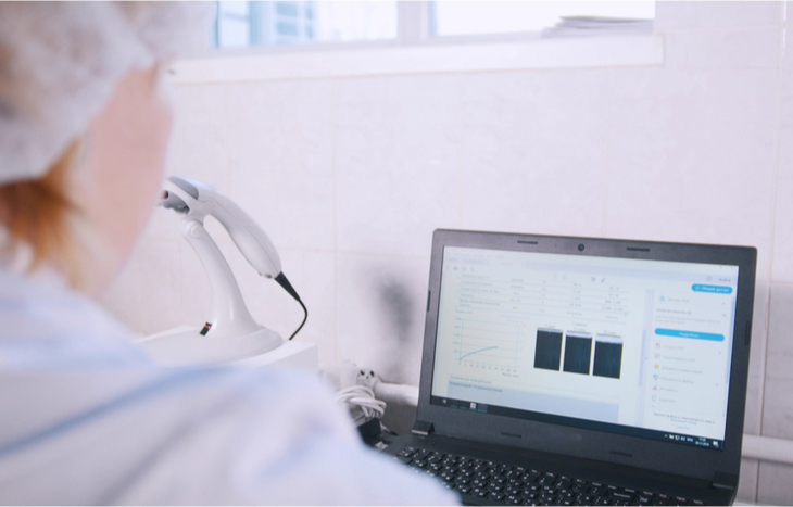 A woman learning how to invest in biotech stocks