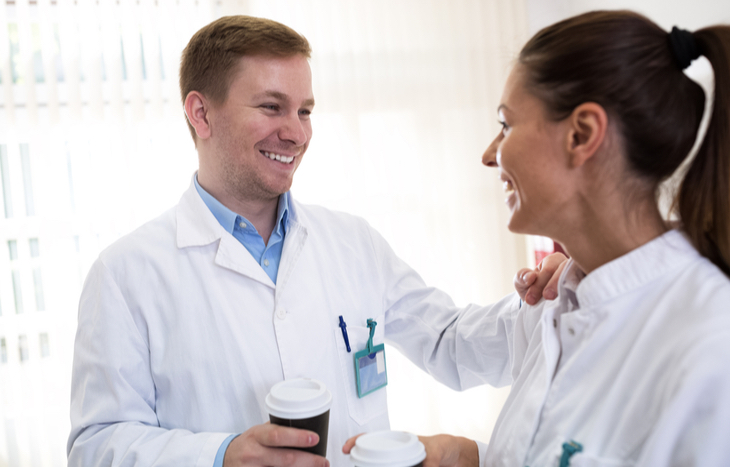 Colleagues discussing small cap biotech stocks