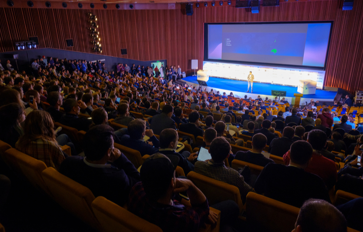 a crypto convention being attended by hundreds of people