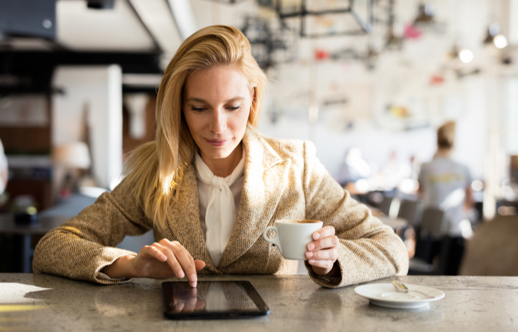 researching coffee stocks while drinking a cup of coffee