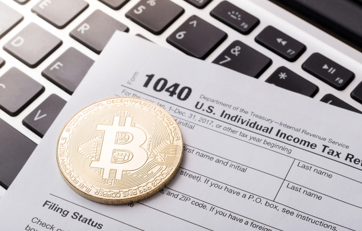 Bitcoin sitting amongst crypto tax forms